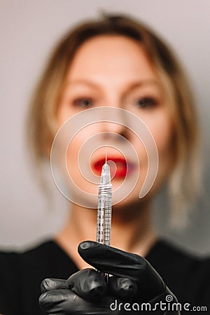 Contour plastic. A cosmetologist injects a botulinum toxin to tighten and smooth out wrinkles on the skin of a female face Stock Photo