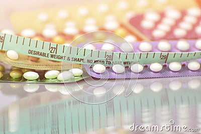 Contraceptive pill background in concept of no weight gain effect Stock Photo