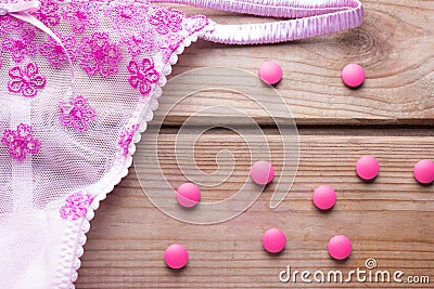 Contraceptive pill and pink lingirie Stock Photo