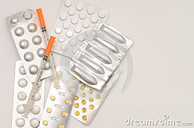 Contraceptive tablets in packages and without on a light background. Stock Photo