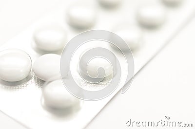 Contraceptive tablets in packages and without on a light background. Stock Photo