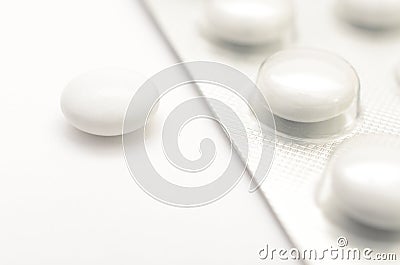 Contraceptive tablets in packages and without on a light background. Stock Photo