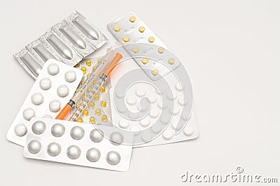 Contraceptive tablets in packages and without on a light background. Stock Photo