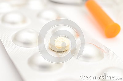 Contraceptive tablets in packages and without on a light background. Stock Photo