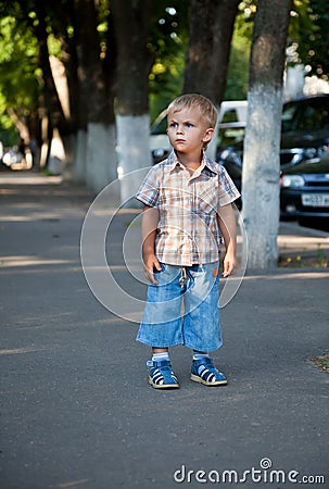 A contracted boy lost in the street Stock Photo