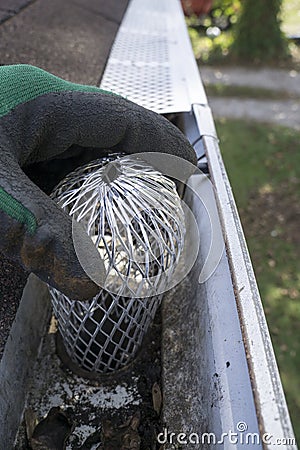 Contractor Checking Installation Of Down Spout Leaf Guard Stock Photo