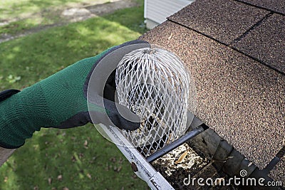 Contractor Installing A Down Spout Filter Stock Photo