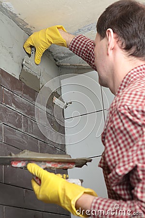 Contractor installing tiles Stock Photo