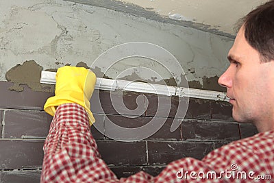 Contractor installing tiles Stock Photo