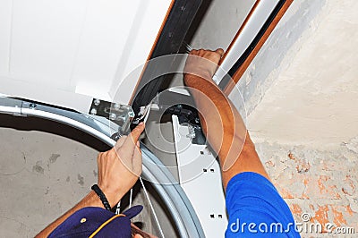 Contractor repair Garage Door Springs. Garage door seal, garage door springs, garage door replacement, garage door repair. Stock Photo