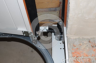 Contractor repair and install garage door. Replace a Broken Garage Door Spring. Stock Photo