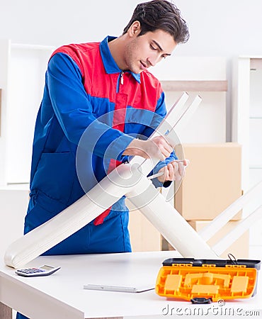 Contractor repairman assembling furniture under woman supervisio Stock Photo