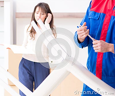 Contractor repairman assembling furniture under woman supervisio Stock Photo