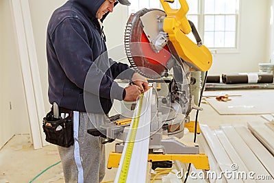 Contractor Using Circular Saw Cutting Crown Moulding for Renovation. Stock Photo