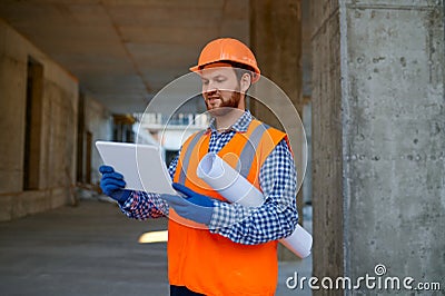 Contractor using digital tablet at construction site Stock Photo