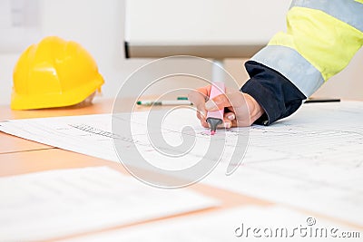 Contractor Using Pink Highlighter On Blueprint Stock Photo