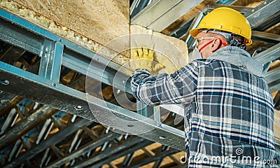 Contractor Worker Installing Mineral Wool Insulation Stock Photo