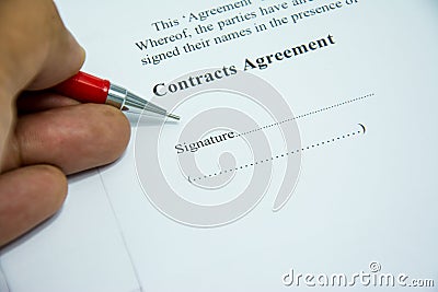 Contracts agreement sign on document paper with red pen Stock Photo