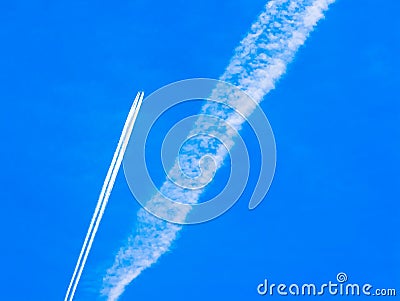 Contrails of aircraft against a blue sky Stock Photo