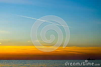 Contrails of aircraft in the blue sky at sunset Stock Photo