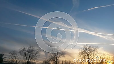 Contrails at sunset Stock Photo