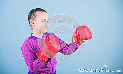 Contrary to stereotype. Boxer child in boxing gloves. Confident teen. Enjoyment from sport. Female boxer. Sport Stock Photo