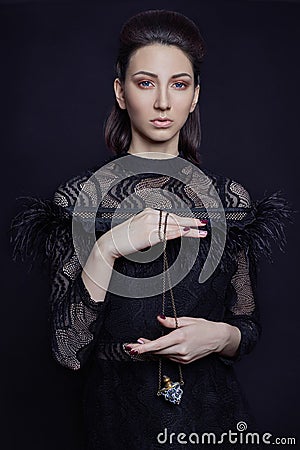 Contrast fashion woman portrait with big blue eyes on a dark bac Stock Photo