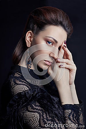 Contrast fashion woman portrait with big blue eyes on a dark background in a black dress. Lovely gorgeous girl posing in evening Stock Photo