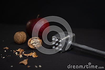 Contrasts Unveiled: Apple, Cracked Nut, and Hammer Stock Photo