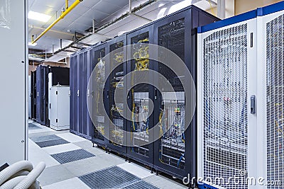 Control modules with modern communication equipment, switches and cables in server room. Data center with control Stock Photo