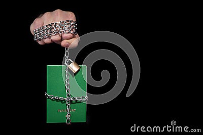 Control over humanity. Passport tied with a chain, on a black background Stock Photo