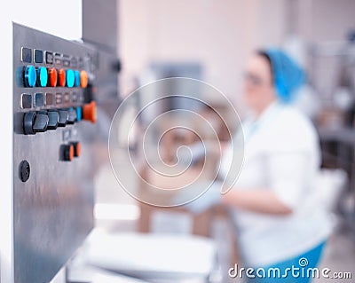 Control panel of an automatic line in production. Woman worker packs products at the factory. Industry, copy space Stock Photo