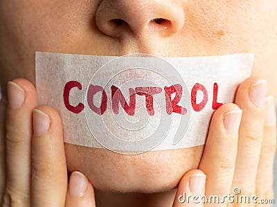 Control your tongue, female holding plastered tape and covering her lips Stock Photo