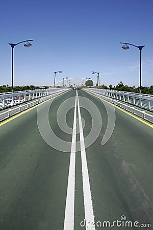 Converging lines of road on bridge Stock Photo