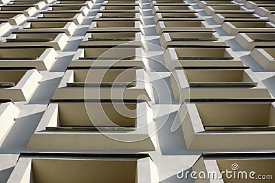 Convex windows of a white building in regular rows. Unusual bottom view of the house Stock Photo