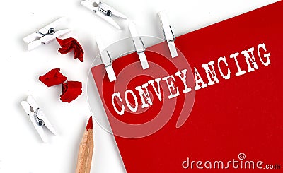CONVEYANCING text on red paper with office tools on the white background Stock Photo