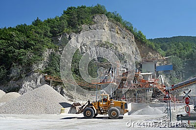 Conveying crushed gravel stone in a quarry open pit mining. Processing plant for crushed stone and gravel. Stock Photo