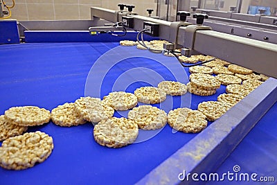 conveyor automatic tape for production of useful whole-grain extruder crispbread Stock Photo