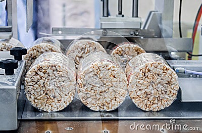 conveyor automatic tape for the production of useful whole-grain extruder crispbread. Stock Photo