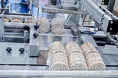 conveyor automatic tape for the production of useful whole-grain extruder crispbread. Stock Photo