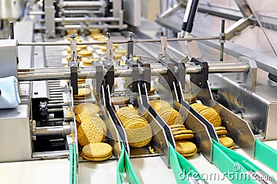 Conveyor belt with biscuits in a food factory - machinery equipm Stock Photo