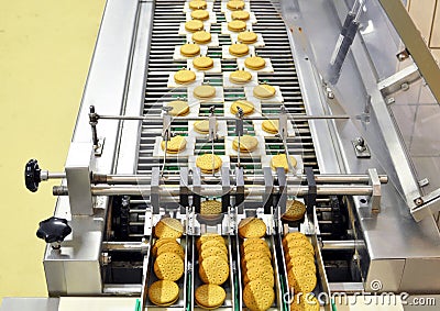 Conveyor belt with biscuits in a food factory - machinery equipm Stock Photo