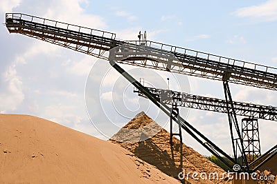 Conveyor belts and sand heaps. Construction industry. Horizontal photo Stock Photo