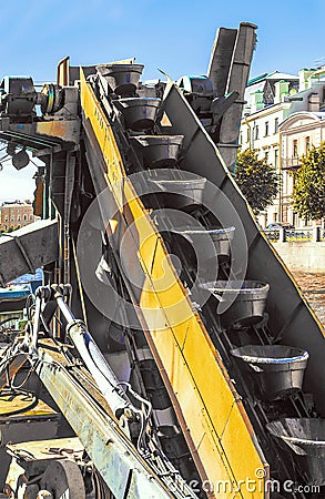 The conveyor buckets on the excavator dredger Stock Photo