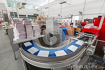 The conveyor with magazines. Printing factory. A stream of journal production. Stock Photo