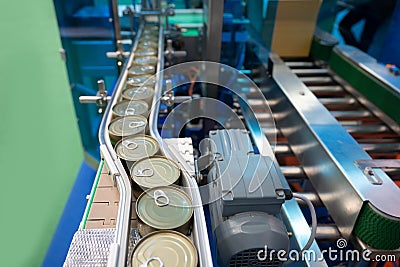 Conveyor for the production of cans in factory. closed tin cans - Canned foods industry. Stock Photo