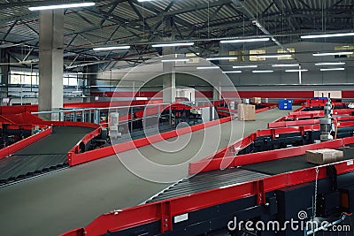 Conveyor sorting belt at distribution warehouse. Distribution hub for sorting packages Stock Photo