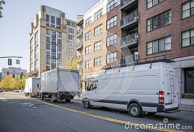 Convoy of different trucks with box trailers and long compact mini van Stock Photo