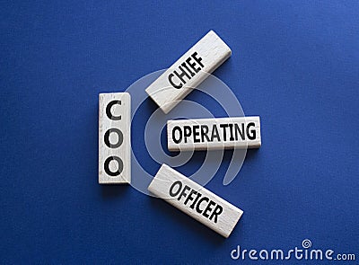 COO - Chief Operating Officer symbol. Concept word COO on wooden blocks. Beautiful deep blue background. Business and COO concept Stock Photo