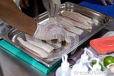 Cook arranging fish on a tray Stock Photo